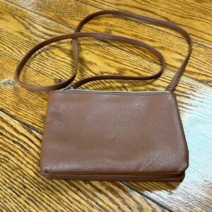 Brown synthetic leather triple compartment crossbody bag. Small wallet size.